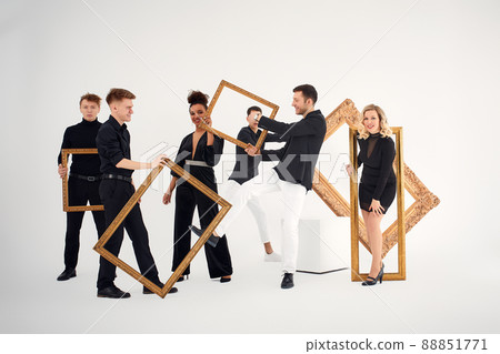 studio portrait of Beautiful young diverse group of friends isolated on white background in the frame for a picture, goofy face, good mood studio portrait of Beautiful young diverse group of friends isolated on white background in the frame for a picture, goofy face, good mood 88851771