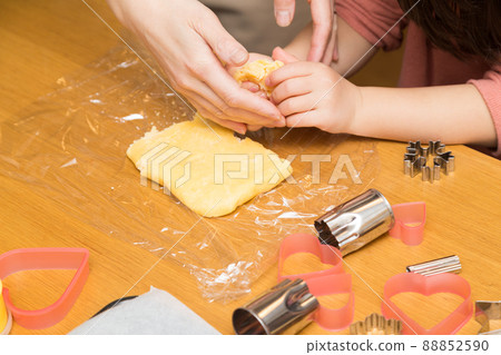 Parent and child making candy 88852590