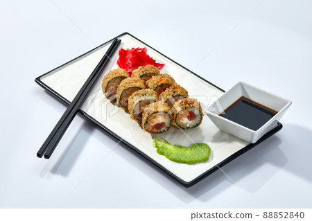 Hot Sushi roll isolated on white background. Traditional fresh Japanese Sushi roll with salmon, avocado, and philadelphia cheese 88852840