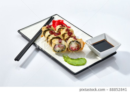 Hot Sushi roll isolated on white background. Traditional fresh Japanese Sushi roll with salmon, avocado, and philadelphia cheese Hot Sushi roll isolated on white background. Traditional fresh Japanese Sushi roll with salmon, avocado, and philadelphia cheese 88852841