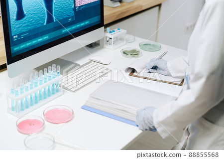 Workplace of modern biotechnologist with flasks, petri dishes and computer 88855568