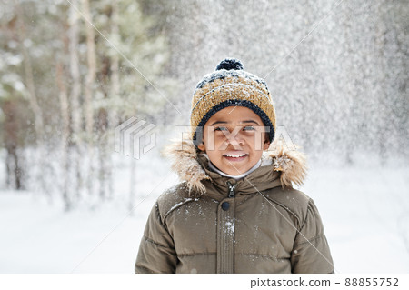 Cheerful little boy of African ethnicity wearing warm winter jacket and beanie Cheerful little boy of African ethnicity wearing warm winter jacket and beanie 88855752