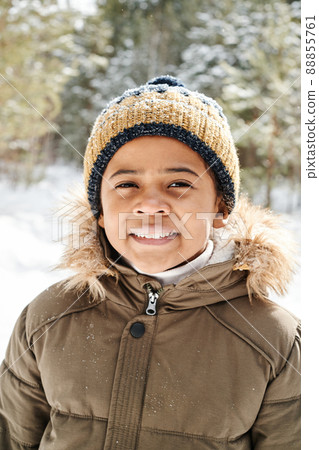 Cute little boy in warm jacket and knitted beanie hat enjoying stroll in park Cute little boy in warm jacket and knitted beanie hat enjoying stroll in park 88855761