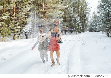 Cheerful African American family in winterwear having fun on snowy day Cheerful African American family in winterwear having fun on snowy day 88855766