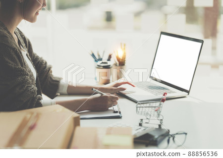 Asian small business owner working at home office. Business retail market and online sell marketing delivery, SME e-commerce concept. Asian small business owner working at home office. Business retail market and online sell marketing delivery, SME e-commerce concept. 88856536