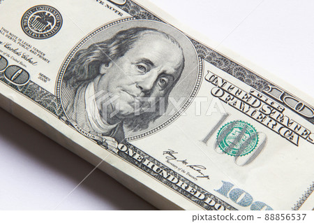 Pack of dollars. A stack of one hundred dollar bills. Lots of new dollars banknotes. Bundle of dollars. Beautiful stack of money background. Business concept. Finance and banking. Isolated. Close-up Pack of dollars. A stack of one hundred dollar bills. Lots of new dollars banknotes. Bundle of dollars. Beautiful stack of money background. Business concept. Finance and banking. Isolated. Close-up 88856537