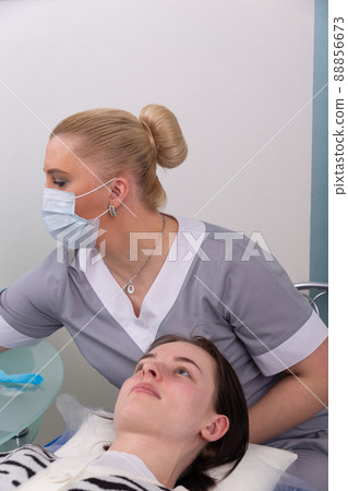 A female cosmetologist is preparing to carry out procedures for the skin care A female cosmetologist is preparing to carry out procedures for the skin care 88856673