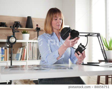 Female photographer talking about new lenses on video blog 88856751