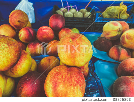 juicy, appetizing peaches of different colors. fruit shop counter, colorful tropical fruits for food. benefits of vitamins, vegan product juicy, appetizing peaches of different colors. fruit shop counter, colorful tropical fruits for food. benefits of vitamins, vegan product 88856898