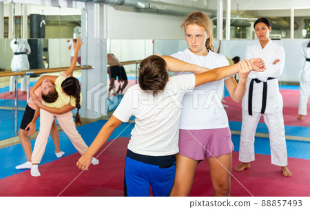 Kids in pair exercising self-defense movements Kids in pair exercising self-defense movements 88857493