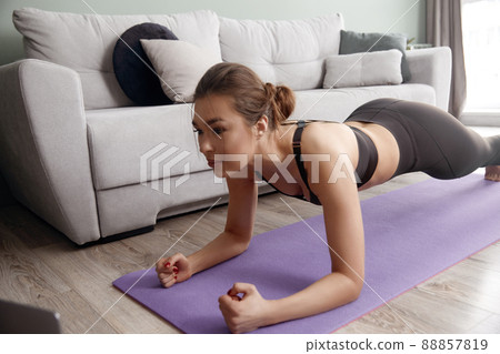 Girl training at home, woman doing plank Girl training at home, woman doing plank 88857819