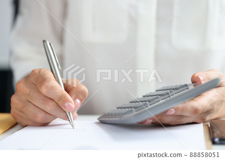 Female accountant or banker making calculations closeup 88858051
