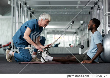 Rehabilitation Therapist with Patient Rehabilitation Therapist with Patient 88858173