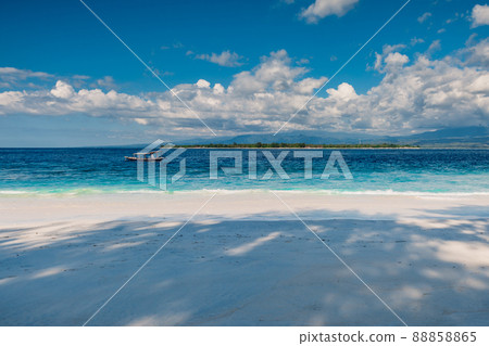 Sandy beach and blue ocean in paradise island. Holiday beach with white sand and sea water Sandy beach and blue ocean in paradise island. Holiday beach with white sand and sea water 88858865