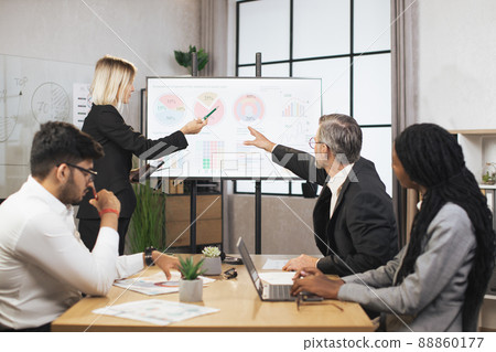 Group of businesspeople, sitting at the table and listening the marketing and financial report 88860177