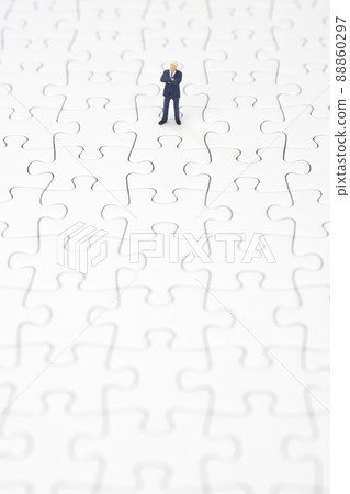 A businessman folding his arms on a jigsaw puzzle 88860297