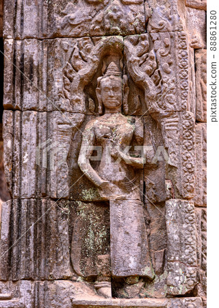 Detail of bas relief sculpture the wall of the ancient Ta Prohm temple in the Angkor Thom Area, Siem Reap, Cambodia. 88861280