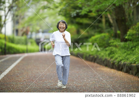 Senior woman jogging with a smile 88861902
