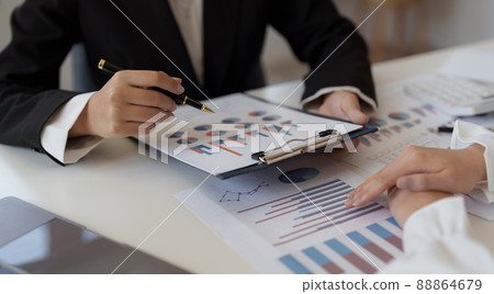 Young business people working together to analyze the current business in which direction to find profit in the business that started to invest 88864679