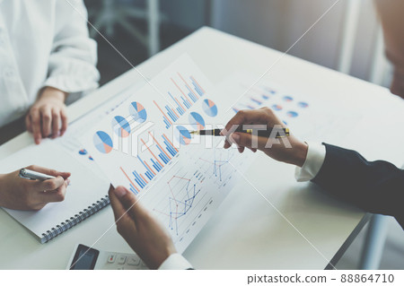 Two business woman investment consultant analyzing company annual financial report balance sheet statement working with documents graphs. market, office,money and tax concept. Two business woman investment consultant analyzing company annual financial report balance sheet statement working with documents graphs. market, office,money and tax concept. 88864710