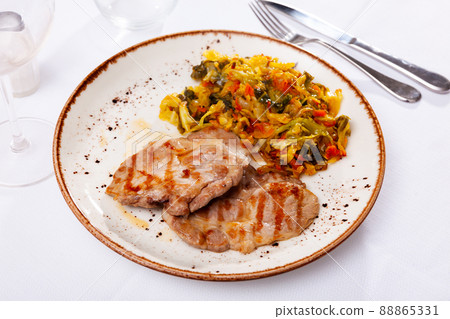 Appetizing cabbage stewed with pork meat on plate 88865331
