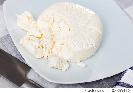Homemade fresh whey cheese from goat milk on plate 88865430