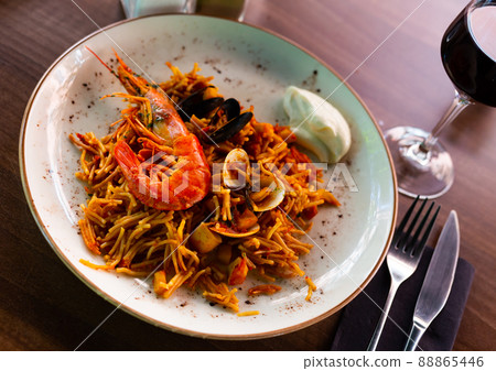Valencian seafood fideua served on plate with sauce allioli Valencian seafood fideua served on plate with sauce allioli 88865446