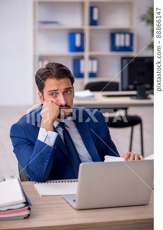 Young male employee working in the office Young male employee working in the office 88866147