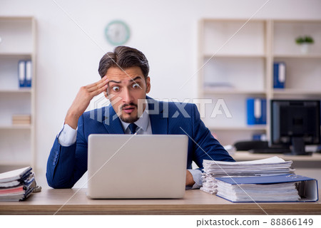 Young male employee working in the office Young male employee working in the office 88866149