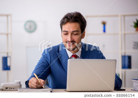 Young male employee working in the office 88866154