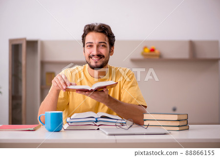 Young male student preparing for exams at home 88866155
