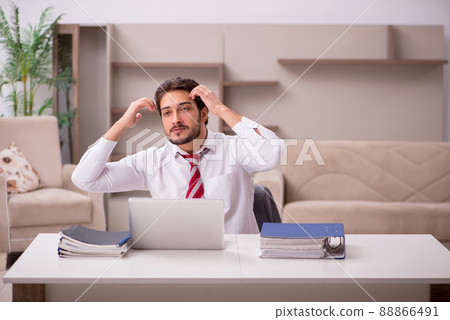 Young male employee working from home during pandemic 88866491
