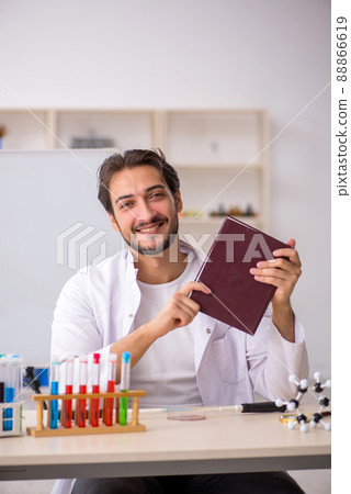 Young male chemist working at the lab 88866619