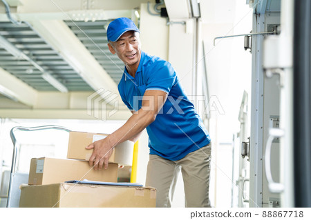 Senior male driver working in a warehouse 88867718