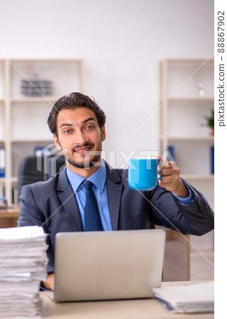 Young male employee drinking coffee during break 88867902