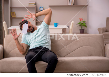 Young man student wearing virtual glasses at home Young man student wearing virtual glasses at home 88867903