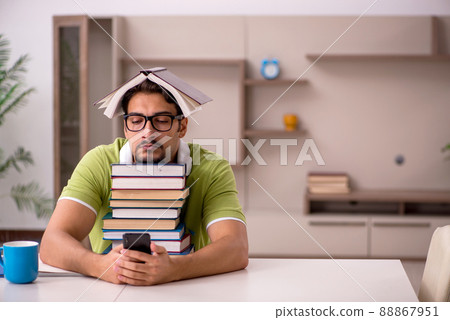 Young male student studying at home 88867951