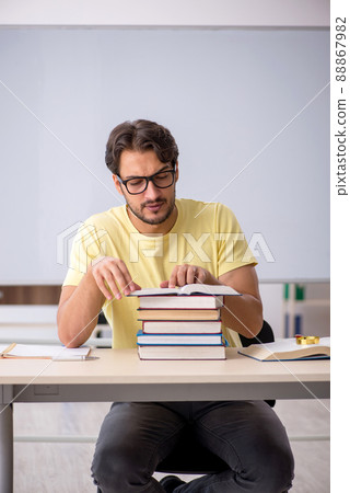 Young male student preparing for exams in the classroom 88867982