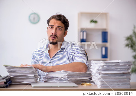 Young male employee unhappy with excessive work in the office 88868014