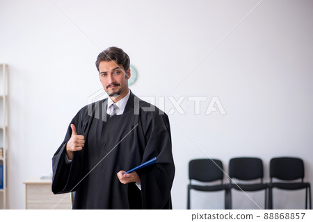 Young male judge working in the courthouse Young male judge working in the courthouse 88868857