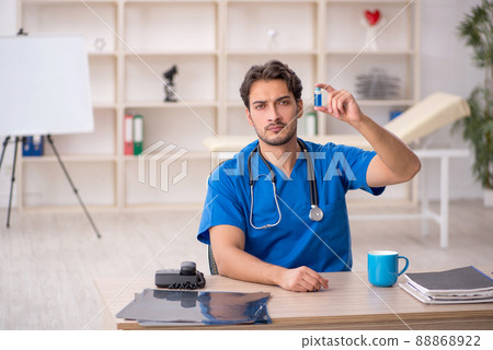 Young male doctor working in the clinic Young male doctor working in the clinic 88868922