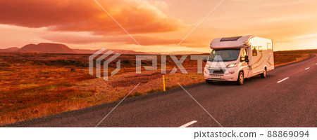 Motorhome camper van RV road trip. People on travel vacation adventure. Tourists in rental car campervan by view of mountains in beautiful nature landscape at sunset Motorhome camper van RV road trip. People on travel vacation adventure. Tourists in rental car campervan by view of mountains in beautiful nature landscape at sunset 88869094