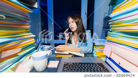 business woman overtime work 88869424