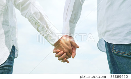 A couple walking hand in hand A couple walking hand in hand 88869430