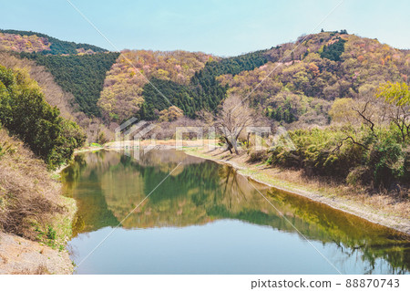 Spring Satoyama river and mountain scenery with young leaves and flowers sprouting Mountains and blue sky reflected on the river surface a-3 Retro film style Spring Satoyama river and mountain scenery with young leaves and flowers sprouting Mountains and blue sky reflected on the river surface a-3 Retro film style 88870743