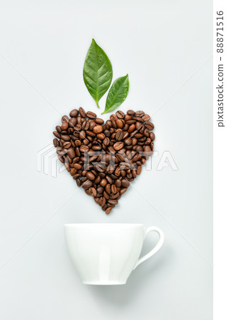 White coffee cup and coffee beans in shape of heart on white background, flat lay 88871516
