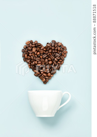 White coffee cup and coffee beans in shape of heart on blue background, flat lay 88871518