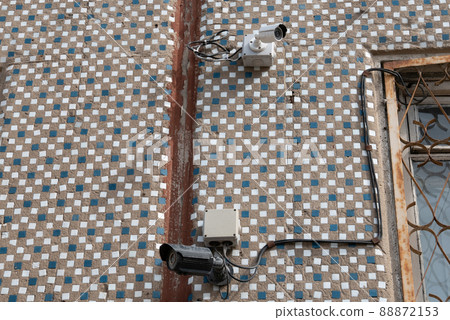 Security Camera, CCTV on location. Security camera on the wall in old city. 88872153
