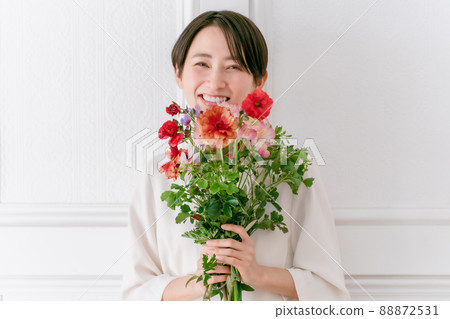 A woman holding a flower smile A woman holding a flower smile 88872531