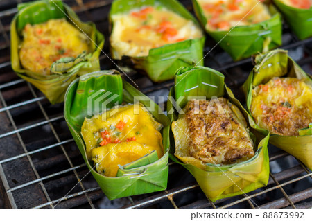Grilling eggs with banana leaves Grilling eggs with banana leaves 88873992